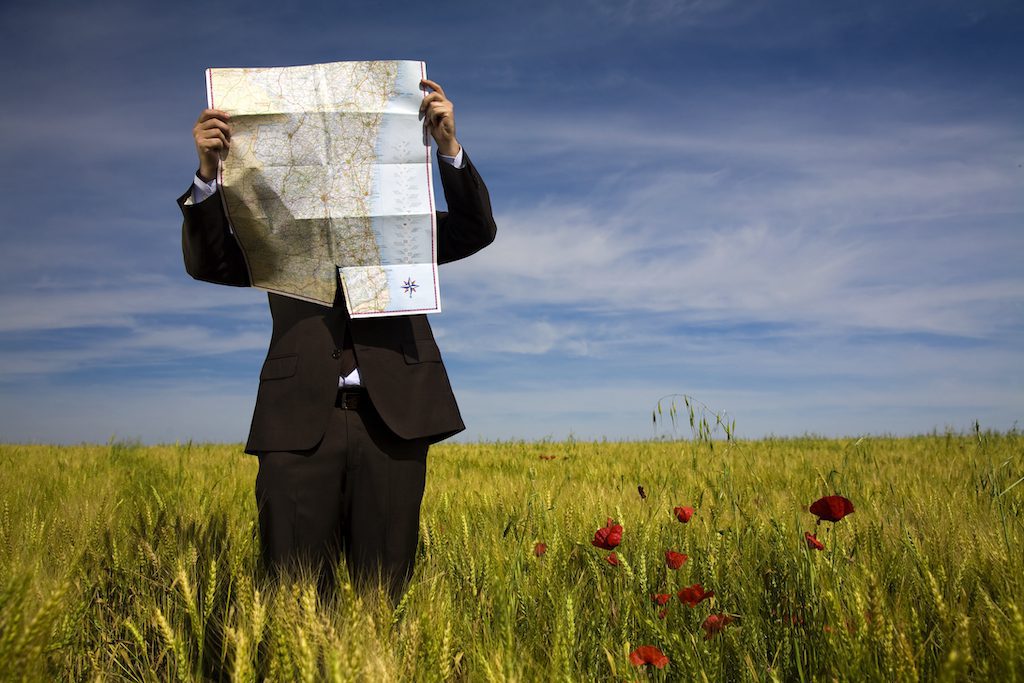 businessman looking at a map wrong