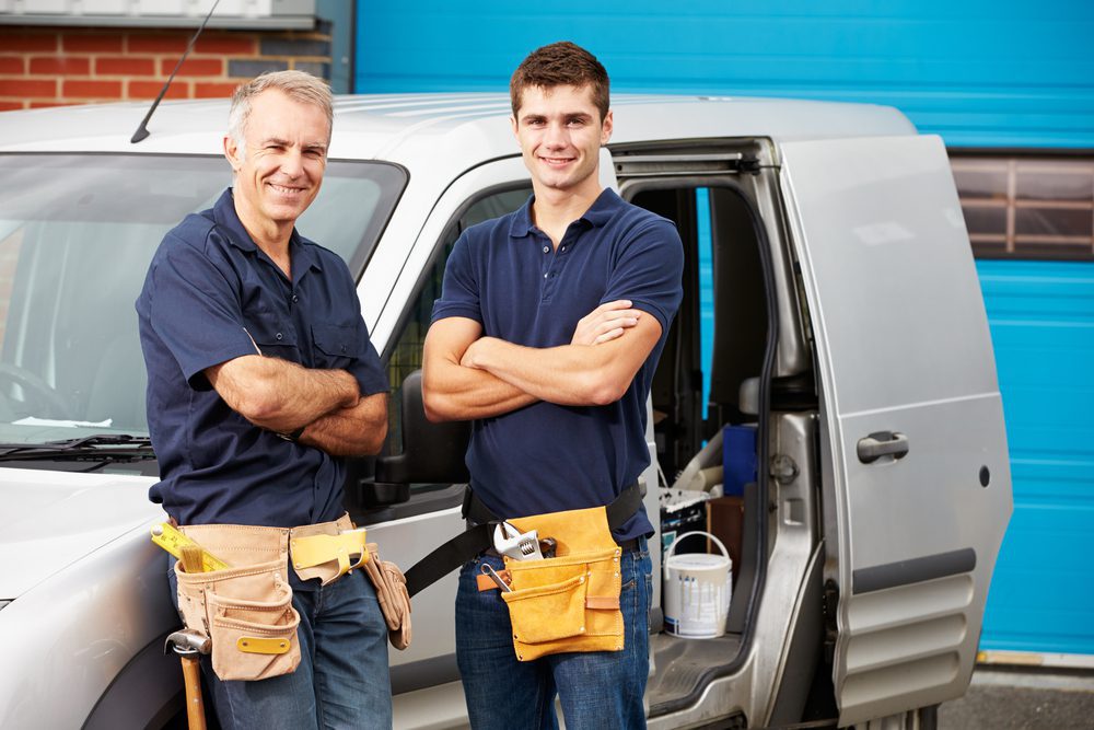 Plumbing business coach - plumbers in front of van