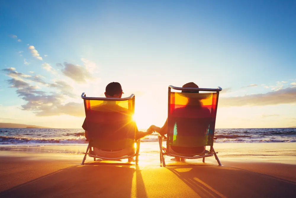 Exit planning | Two retired people sitting in chairs on the beach