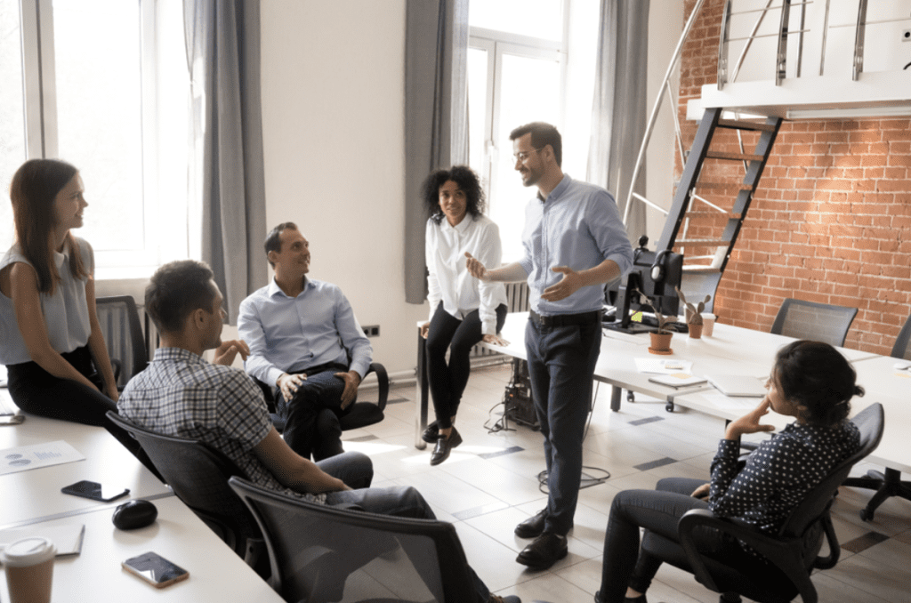 Leadership vs management | Group of people in office having a meeting