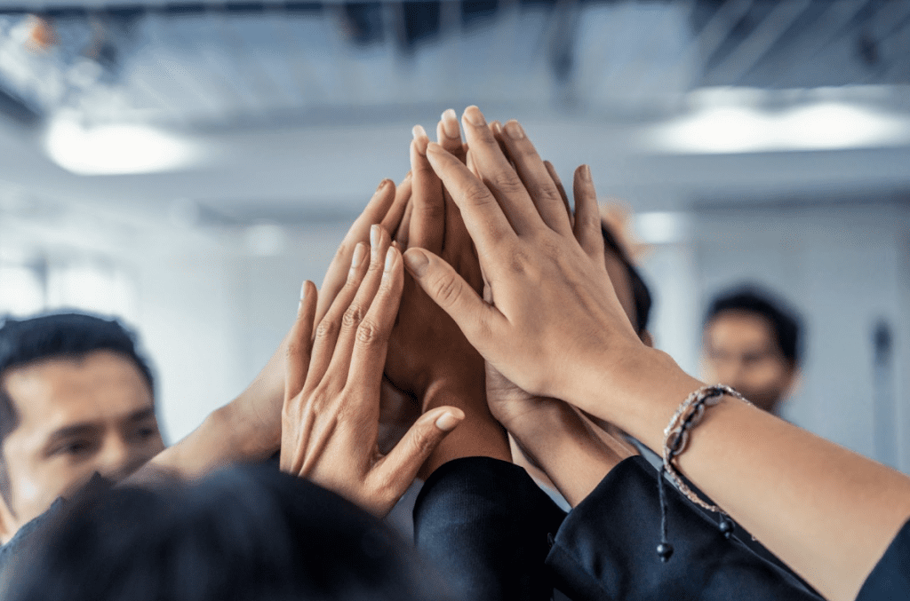 Company culture | Group of people high-fiving.