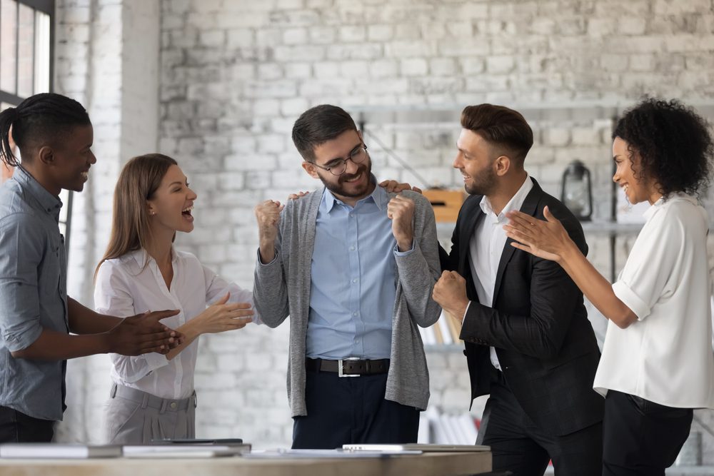 What motivates people to work | people celebrating an employee