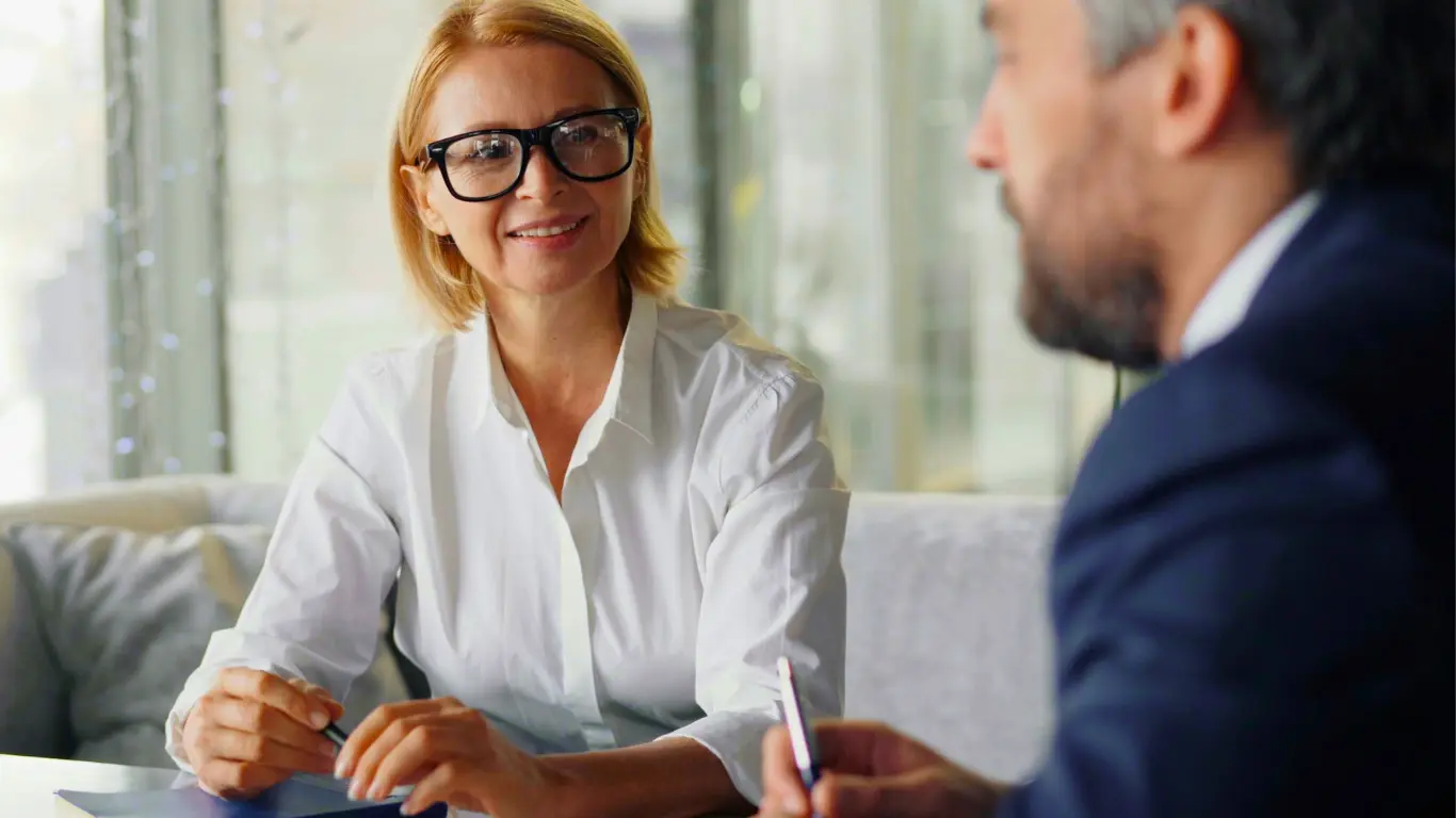 man and woman talking about business coaching services