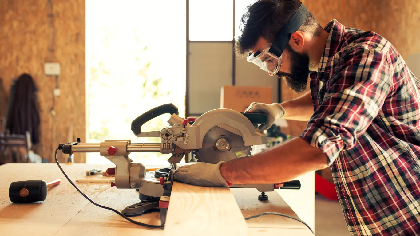 creative professional carpenter bespoke joiner working using a circular saw