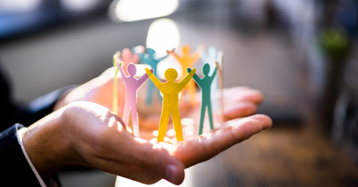 leadership training course circle of paper people in a hand